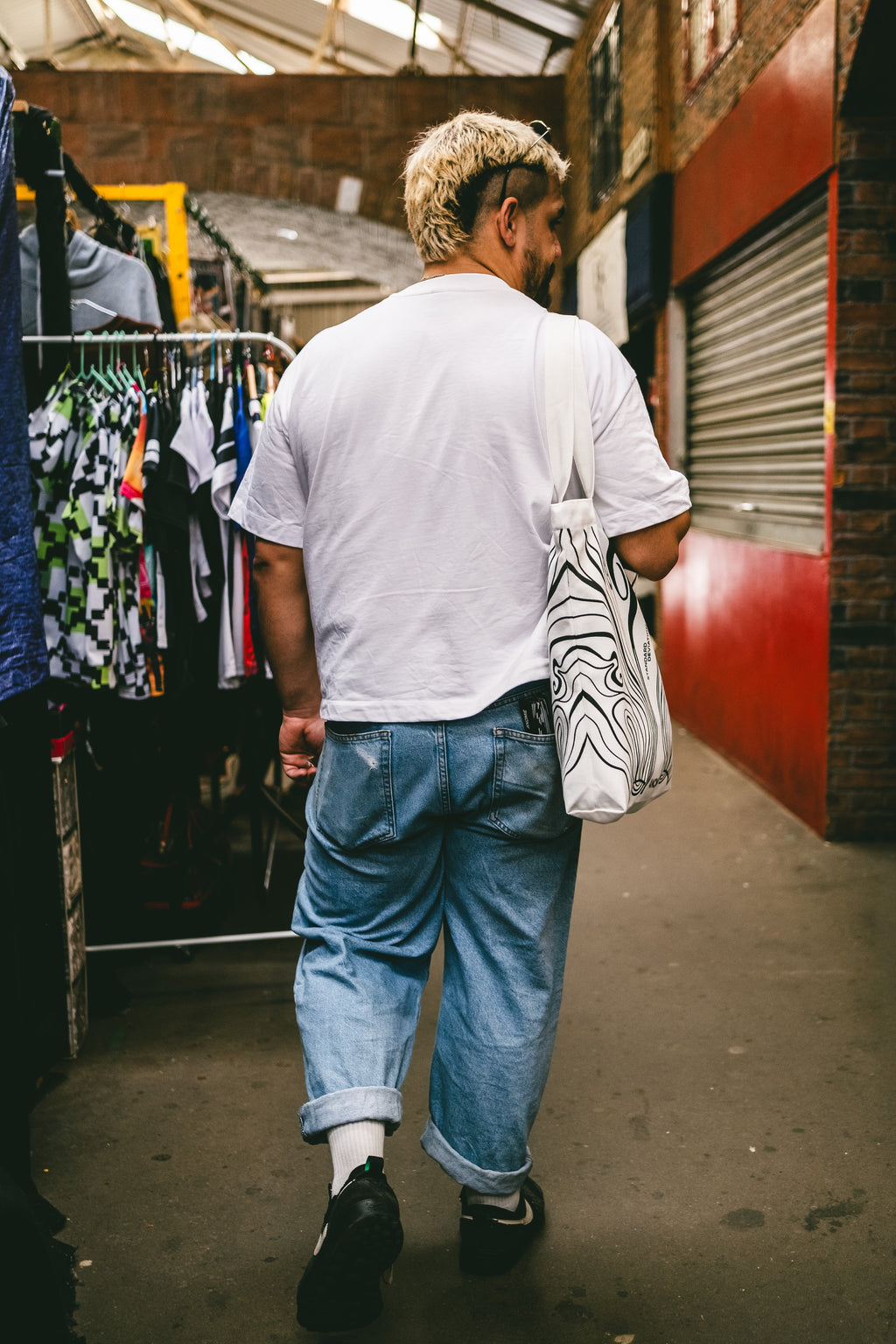 Model wearing NOTHING PURE SURVIVES TEE by Anomie, back view.
