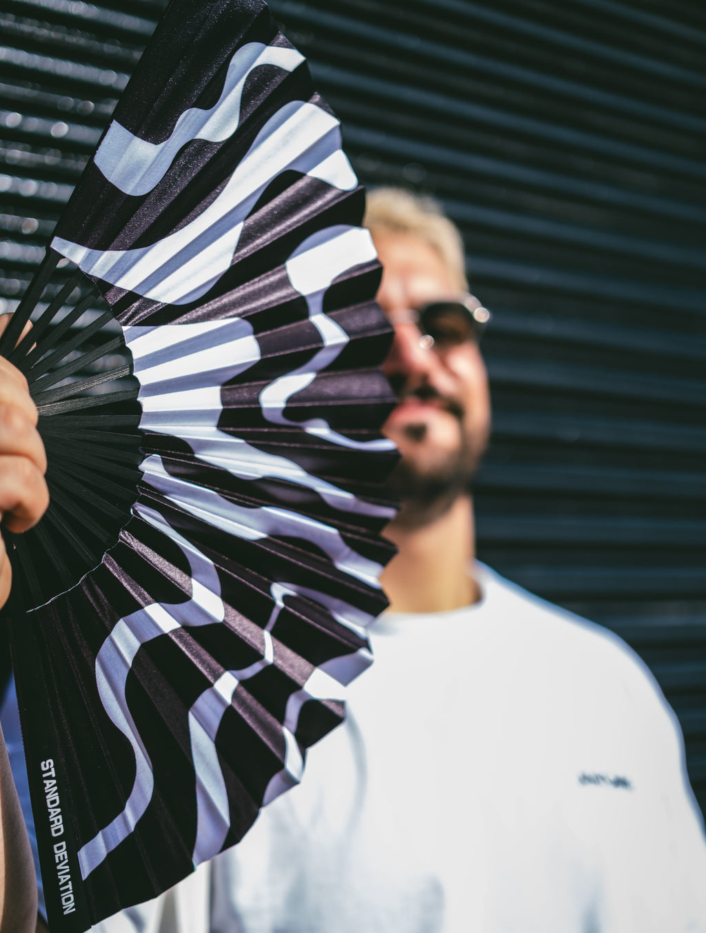 Model using SWEATBOX HAND FAN by Anomie. 