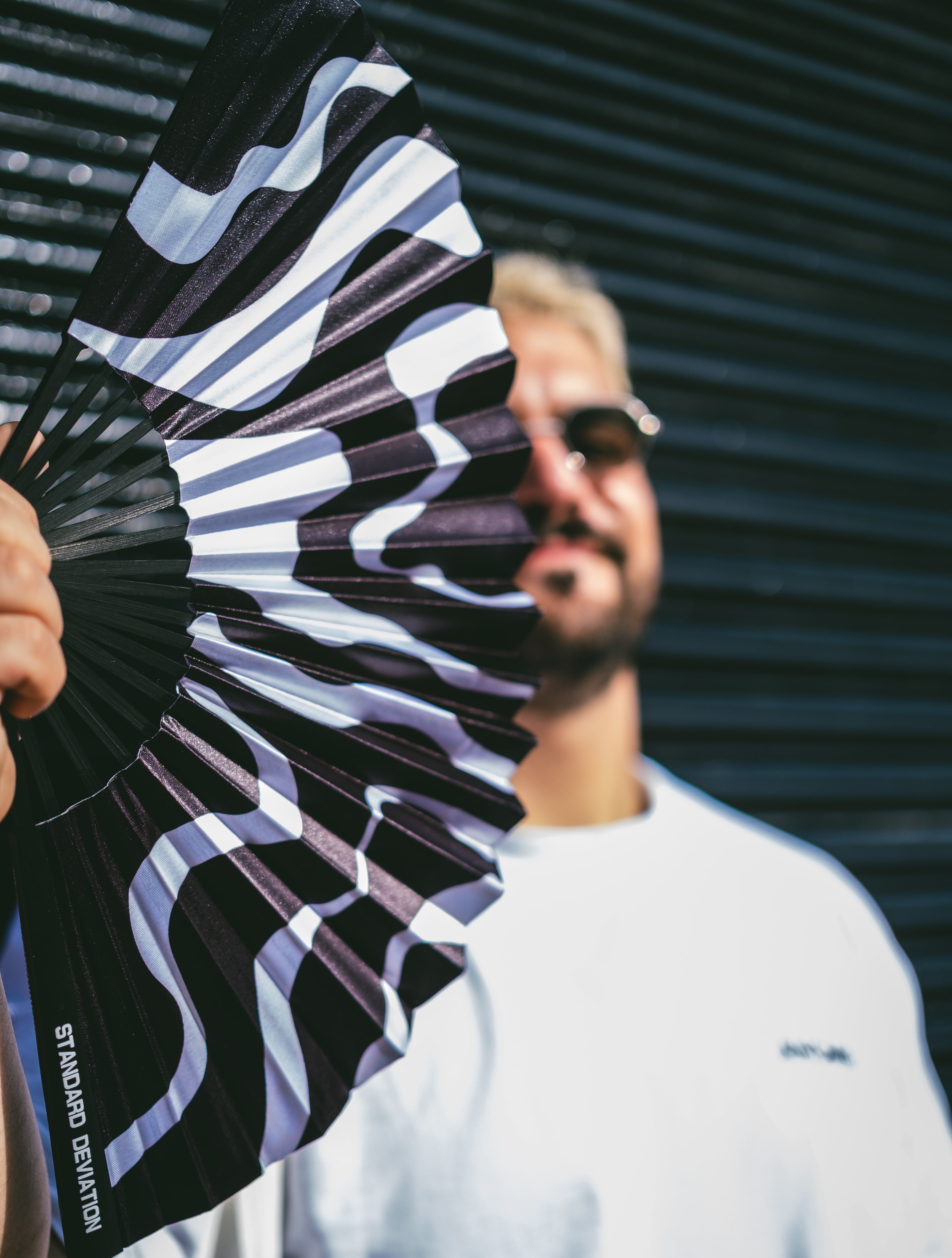 Model using SWEATBOX HAND FAN by Anomie. 